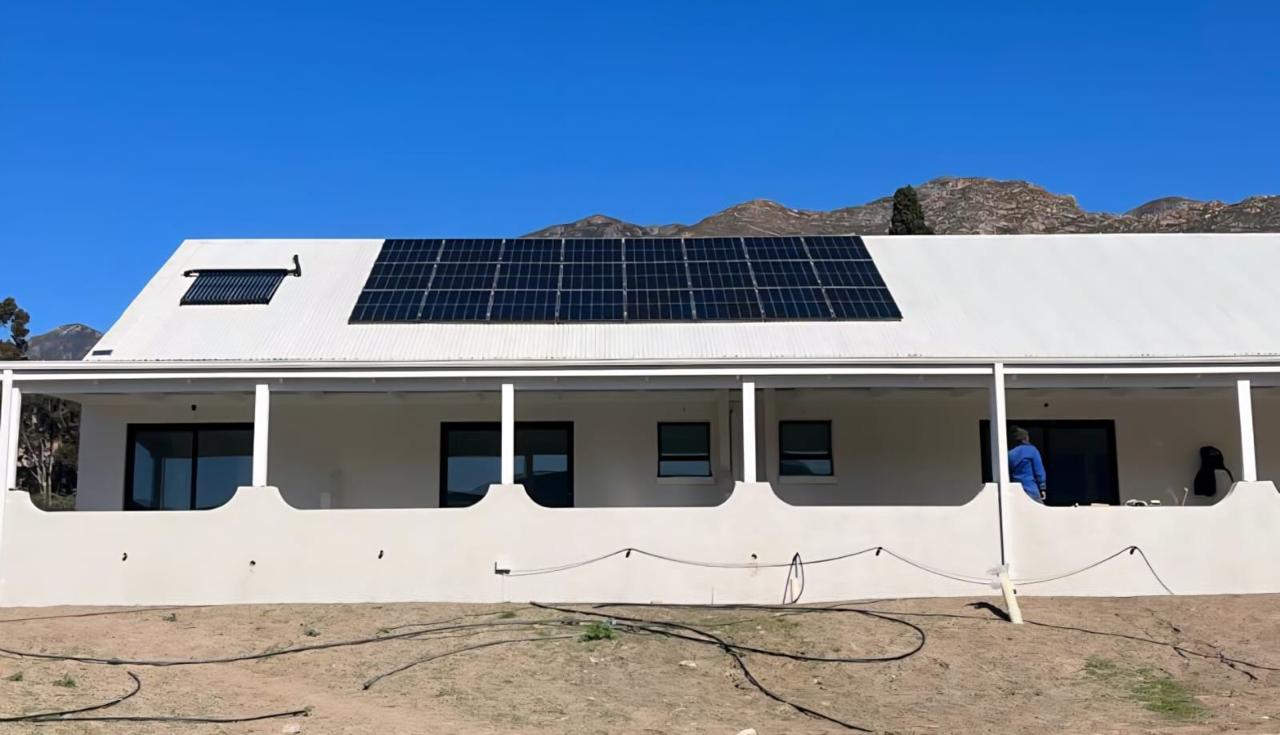 Rooftop solar panel installation on a farmhouse