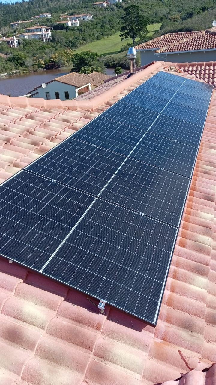 Solar panel array on tiled roof overlooking the lagoon
